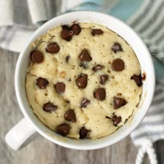 a chocolate chip cookie in a mug with text overlay that reads vanilla mug cake with chocolate chips