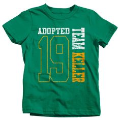 "Kids Personalized Adopted T Shirt Matching Custom Matching Family Shirts Adoption Adopting Tee Athletic Team TShirt Toddler Let everyone know that you're officially become a family in this personalized adoption t shirt. This tee will be personalized with your family name and year. Please leave the name, year, and print color preference in the notes section at checkout. The design is big, bold and athletic styled. It will feature the last two digits of the year the adoption happened as well as t Green Short Sleeve Team Spirit T-shirt, Green Graphic Tee With Team Name, Green Short Sleeve Tops With Name Print, Green Short Sleeve Top With Name Print, Green Crew Neck Top With Team Spirit Style, Green Crew Neck Top For Team Spirit, Casual Green Shirt With Name Print, Green Casual Shirt With Name Print, Green Team Spirit Short Sleeve T-shirt