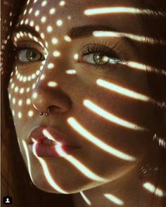 a woman's face with light shining on her skin and the image is made up of