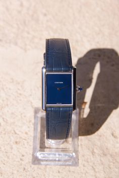 The Cartier Tank Must WSTA0055, also known as the Cartier Tank Must Bleu, is part of the rich history of the Tank de Cartier collection, one of the brand's most iconic and enduring watch collections. Brand: Cartier Model: Tank Must Reference number WSTA0055 Gender: Men / women Movement: Swiss Quartz Case dimensions: Case size: 25.5 mm x 25.5 mm (33.7 mm with case lugs) Case thickness: 6.7mm Dial: blue Strap: Cartier blue alligator strap with Cartier stainless steel pin buckle. Features: Sword-sh Luxury Collectible Watches, Classic Watches With Rectangular Dial For Collectors, Classic Collectible Watch With Rectangular Dial, Blue Rectangular Timeless Watch, Timeless Blue Rectangular Watch, Elegant Blue Rectangular Watch, Timeless Blue Watches For Anniversary, Classic Collectible Watches With Diamond Hour Markers, Blue Rectangular Business Watches