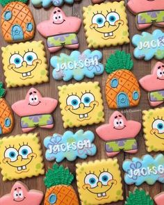 decorated cookies with cartoon characters and pineapples are displayed on a wooden table top