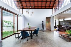 a dining room table with blue chairs in front of it and an open floor plan