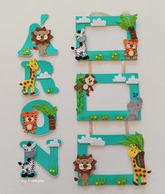 three wooden frames with animals and trees on them