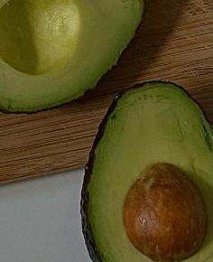 an avocado cut in half on a cutting board