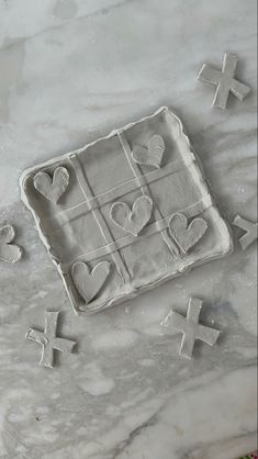 some cookies that are sitting on top of a cookie sheet with hearts and crosses in the middle