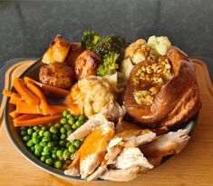 a plate filled with meat, vegetables and bread