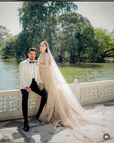 a bride and groom pose for a wedding photo