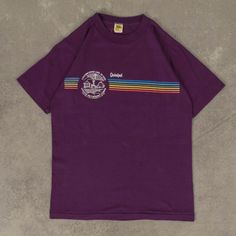 Women's Vintage 1980s Quinipet Single Stitch T-Shirt  + Damage: Nick To Front, Minor Marks/Lint Buildup  + Tag: Velva Sheen  + Made In USA  + Material: Cotton Blend  + Colour: Purple  + Size Label States: Small  + Recommended Size: Medium  + Measurements (Inches): Pit To Pit = 17, Body Length = 24  Please note that all vintage items have been previously worn, and may show some signs of previous wear. However, any significant damage will be photographed and/or stated in the items listing. Please Colour Purple, Medium Purple, Size Label, Unique Vintage, Womens Clothing Tops, Vintage Ladies, Violet, Vintage Items, Cotton Blend