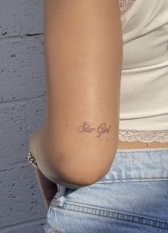 a woman with a small tattoo on her arm