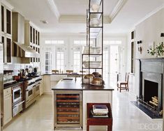 a kitchen with an oven, stove, and ladder in it's center island