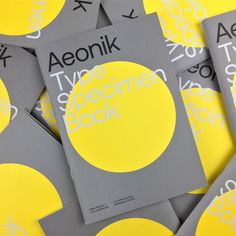 the type specimen book is yellow and grey with white letters on it, surrounded by smaller gray and yellow circles