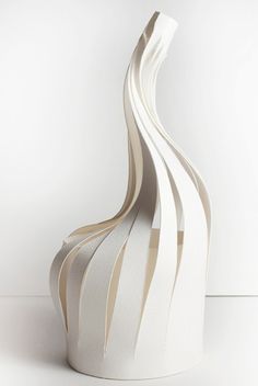 a white vase sitting on top of a table