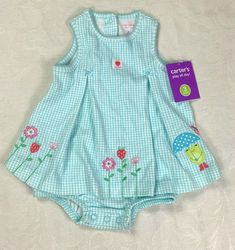 Up for sale is a Super Cute NWT Infant Girls' Carter's "Play All Day" Aqua Blue Gingham Sun Dress in Size 3 months. Labeled as ideal for babies 21 1/2-24" in length, weighing 8-12 1/2 lbs. Soft, comfortable, lightweight material with stretch.  100% Cotton. This cute dress has an aqua blue gingham print.  Colorful embroidered flowers in shades of pink, green, and white decorate the hem.  On far left of hem, a smiling frog holds up a polka-dotted umbrella.  So precious! An adorable white patch on Playful Cotton Dress For Picnic, Spring Blue Plaid Cotton Dress, Cute Cotton Dresses For Picnic, Cute Spring Plaid Dress, Cute Plaid Dress For Spring Picnic, Cute Sleeveless Spring Plaid Dress, Cute Sleeveless Cotton Plaid Dress, Blue Cotton Picnic Dress, Spring Cotton Sleeveless Plaid Dress