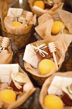 baskets filled with lemons and cheese on top of a wooden table next to other items