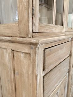 an old wooden cabinet with glass doors