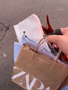 a person holding shopping bags on the street