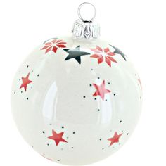 a white ornament with red and black stars on it