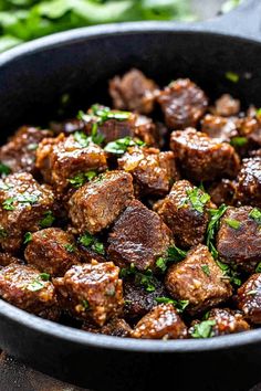 meatballs with parsley in a skillet on a wooden table, ready to be eaten