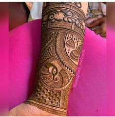 a woman's hand is decorated with hennap and intricate designs on it