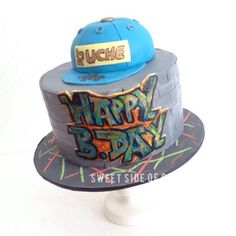 a birthday cake with the words happy b - day on it and a blue hat