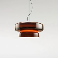 an orange light hanging from a ceiling fixture