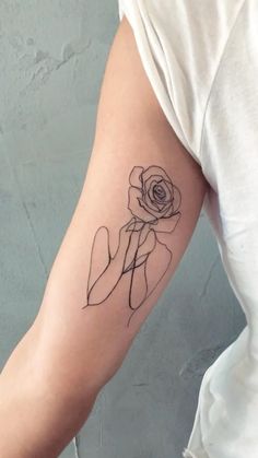 a woman with a rose tattoo on her arm