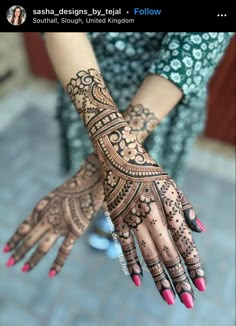 a woman's hand with henna tattoos on it