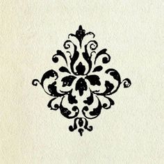 a black and white drawing of an ornate design on a piece of paper that has been drawn with ink