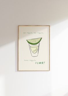 a framed art print with a lime slice on the bottom and words below it that read, flor