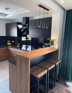 a kitchen with an island and stools in it