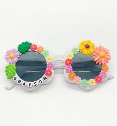 a pair of sunglasses with flowers and the words grayson written on it, are shown in front of a white background