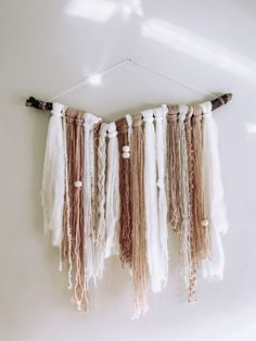 the wall hanging is decorated with different types of tassels