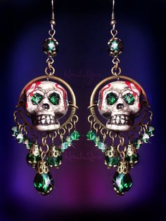 "These Dangly Crystal Gothic Skull Chandelier Earrings are made with sparkling crystal beads and hand-painted skulls with rhinestone eyes. The painted dripping blood and antiquing makes this pair super scary! Love these for an everyday Gothic or Dark style. They're fun to wear and make a statement. Available with Posts, Clip-Ons or French Wires. -3 1/2\" Long x 1\" Wide -0.4 oz. ea. Metal Finishes Available: -Bronze -Silver Colors Available: -Black Cat -Witchy Purple -Spooky Green -Blood Red *Co Bohemian Halloween Party Jewelry, Bohemian Jewelry For Halloween Party, Unique Halloween Party Jewelry, Gothic Skull Earrings For Party, Nickel-free Skull Jewelry For Party, Halloween Fantasy Dangle Jewelry, Fantasy Halloween Dangle Jewelry, Skull Shaped Jewelry For Day Of The Dead Party, Skull Jewelry For Day Of The Dead Party