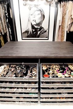 an image of a closet with drawers and clothes on the shelves in front of it