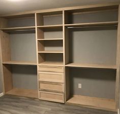 an empty walk in closet with shelves and drawers