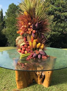 a glass table topped with lots of fruit and vegtables on top of it