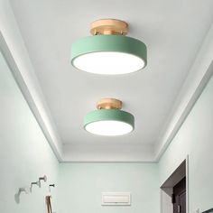 a bathroom with two round lights on the ceiling