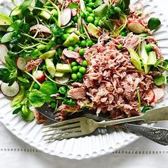 a white plate topped with meat and veggies