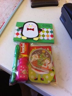 a desk with various items on it including candy, pens and an animal shaped object