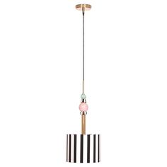 a black and white striped lamp hanging from a gold ceiling fixture with a pink light bulb