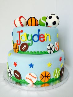 a birthday cake decorated with sports balls and stars