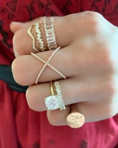 a woman's hand with three different rings on her fingers and one has a diamond ring