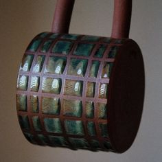 a brown and green object hanging from a hook