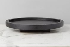 a black tray sitting on top of a marble counter