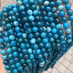 a person holding a bunch of blue beads