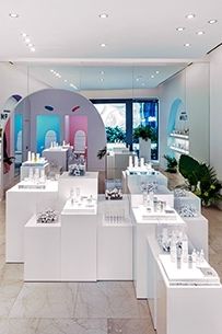 a room filled with lots of white counter top space next to a large wall mounted mirror