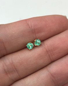 Made just for our beloved babies, these are our Colombian emerald studs set in 14K yellow gold. These earrings are screw backs with protective backing so it is comfortable for your precious, little one. Medium-green emeralds with incredible transparency, accented by a simple four-prong 14k yellow gold mount, allowing for the emerald to be shown in full view. The earth-mined, green Colombian emeralds have a desirable lush green color with excellent qualities. These earrings are ideal for everyday Hypoallergenic Green 14k Gold Jewelry, Hypoallergenic 14k Gold Green Jewelry, May Birthstone Earrings With Prong Setting In Round Cut, May Birthstone Earrings With Prong Setting, May Birthstone Round Cut Earrings With Prong Setting, Green 14k Gold Hypoallergenic Earrings, Hypoallergenic 14k Gold Green Earrings, Green 14k Gold Birthstone Earrings, Yellow Gold Emerald Birthstone Earrings