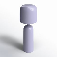 a purple object is standing upright on a white surface