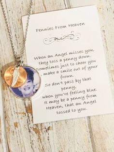 a necklace with an image of a woman's face on it next to a note