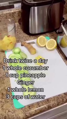 a cutting board with lemons and cucumbers on it next to a slow cooker